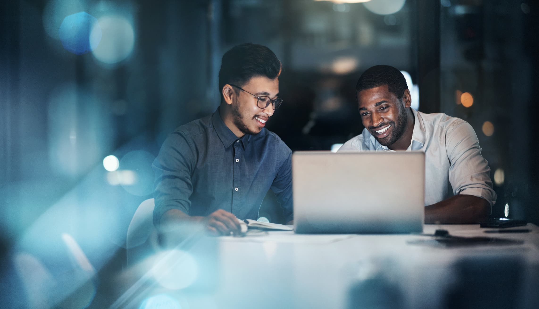 Two-young-businessmen-working-at-office-choosing-between-two-jobs