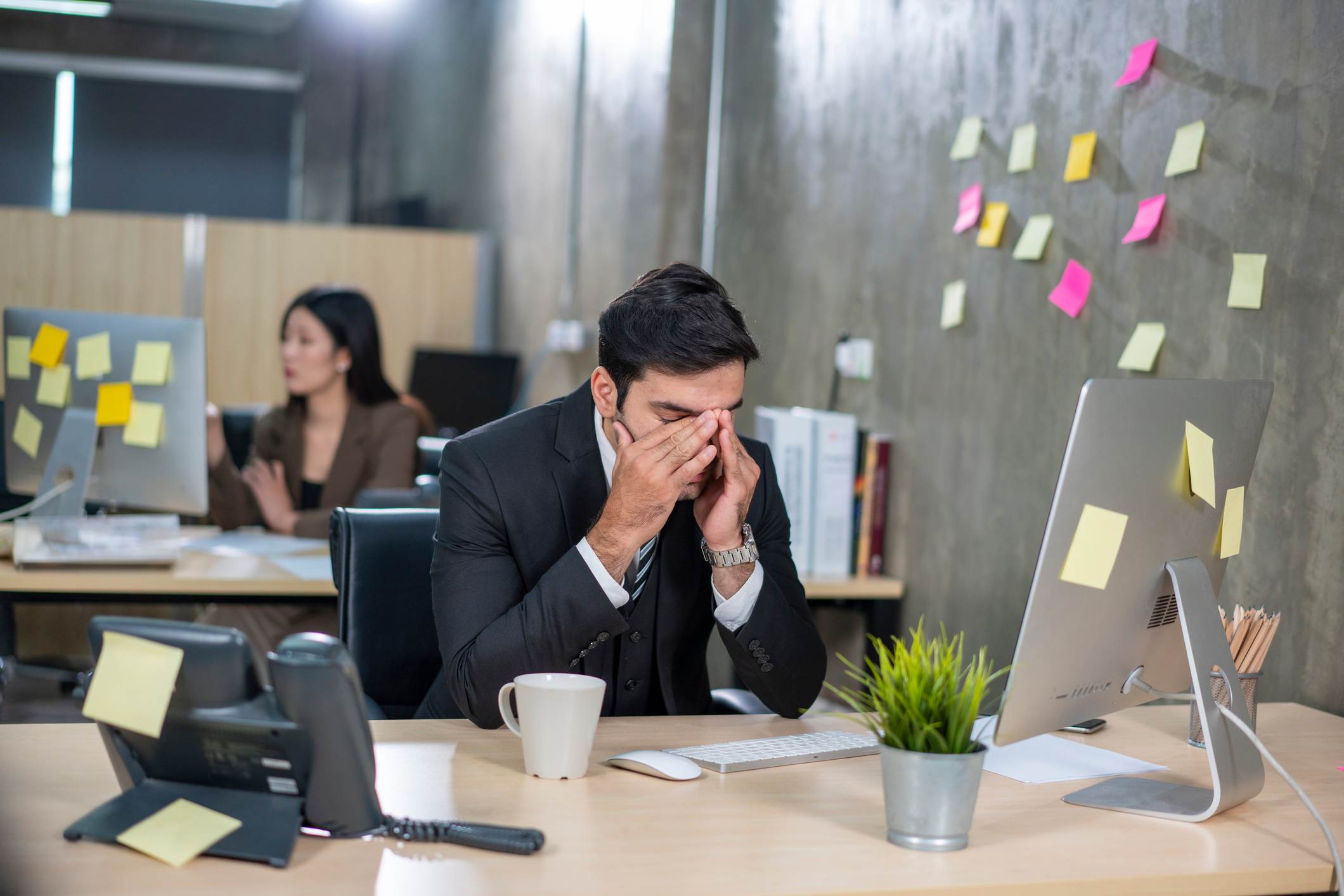 Upset-employee-in-front-of-his-desk-favoritism-in-workplace