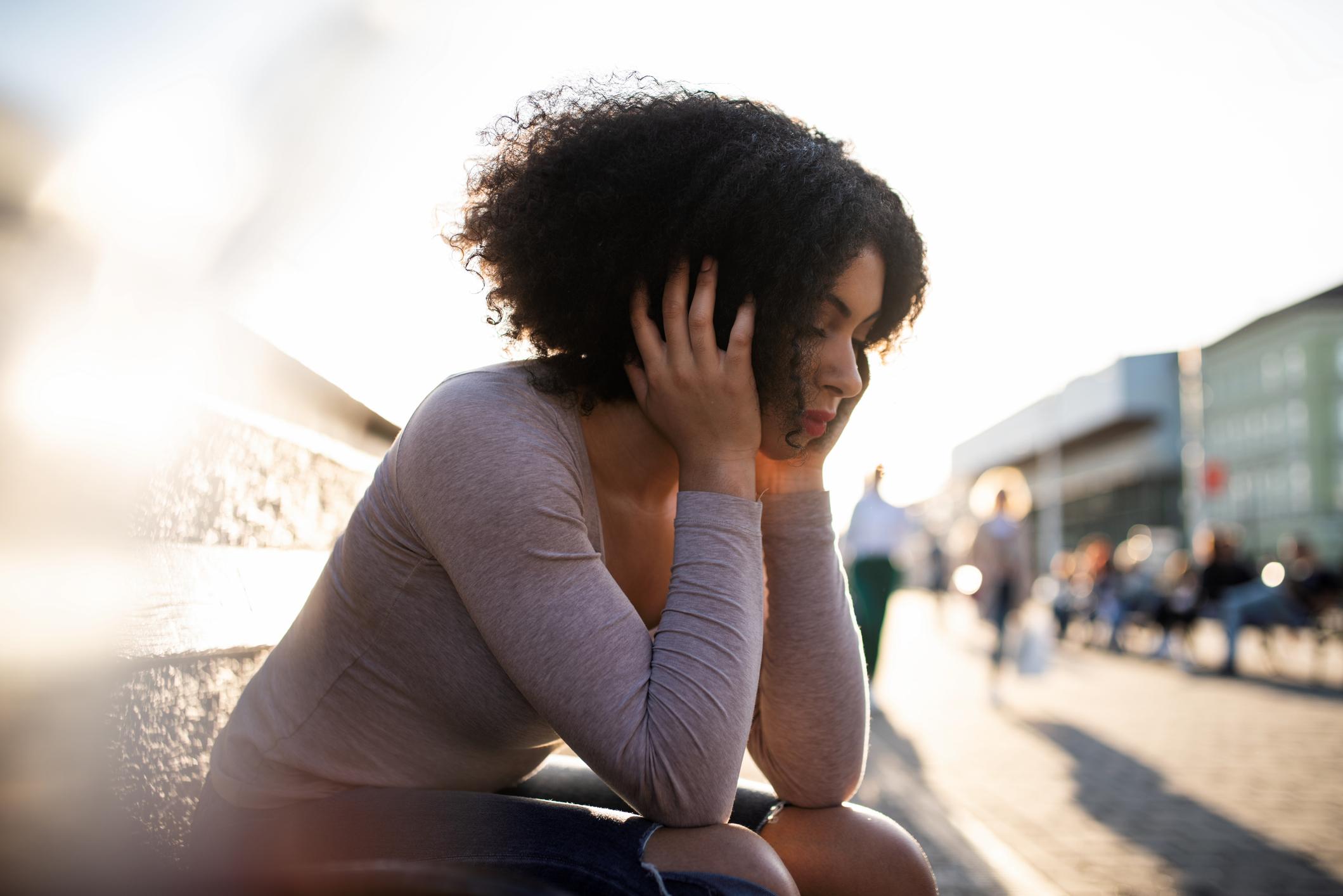 Upset-woman-covering-her-face-alone-at-the-park-what-are-the-emotional-triggers-for-empaths