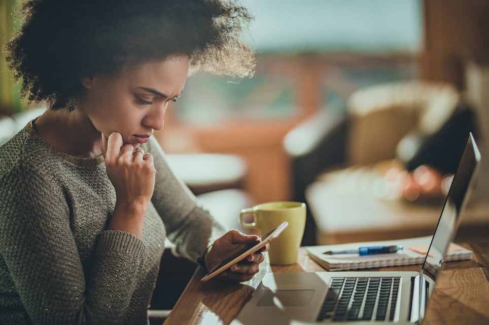 Upset-woman-reading-an-email-from-her-phone-what-to-do-when-you-get-laid-off