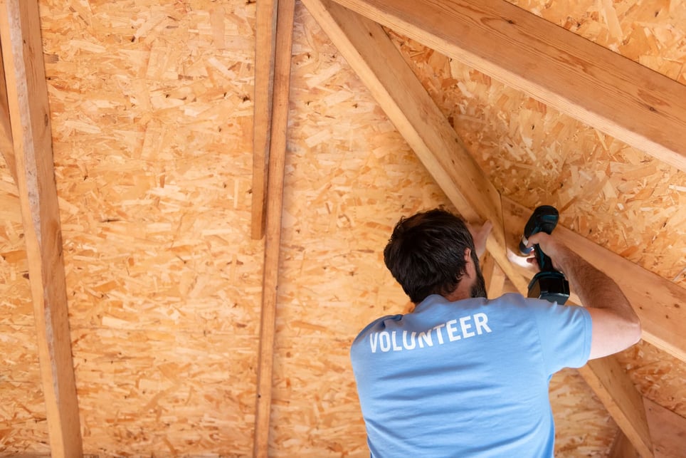 Volunteer-Builder-Drilling-Into-Roof-1