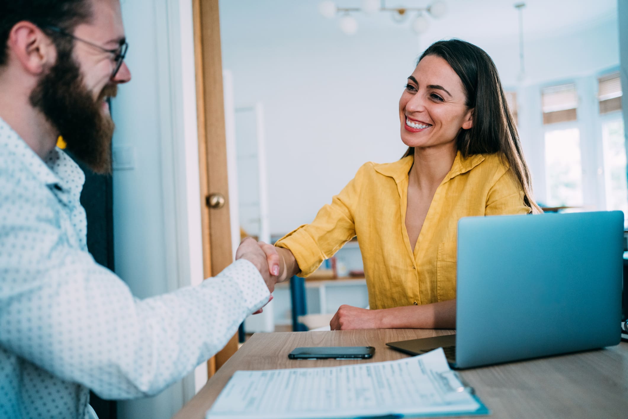 Woman-accepting-job-offer-from-young-bearded-manager-employee-poaching