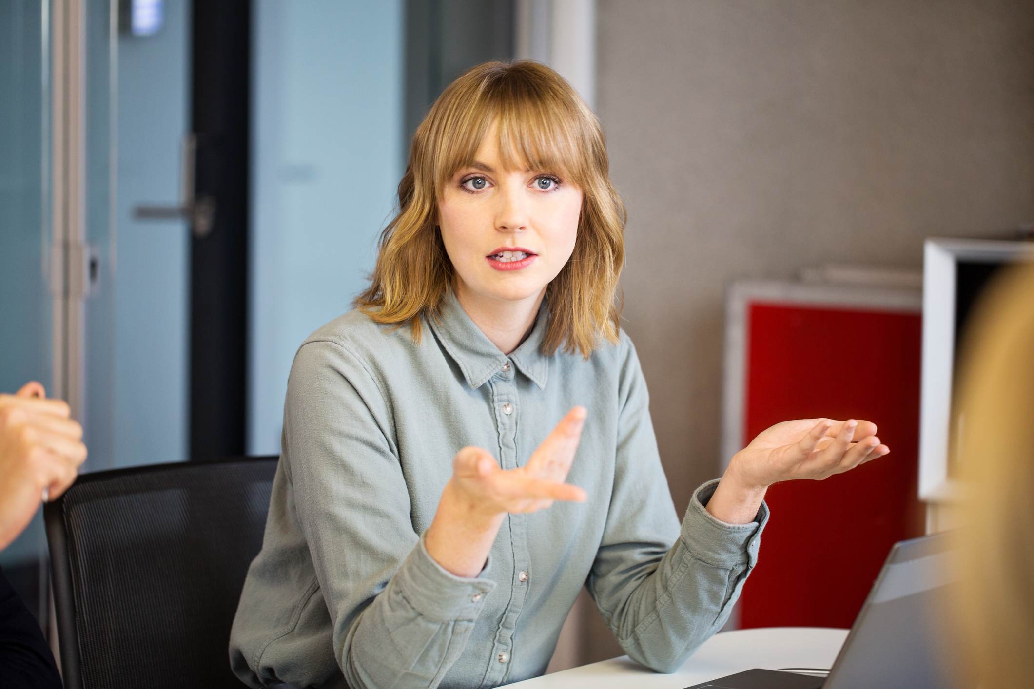 Woman-at-team-meeting-speaking-signs-your-coworker-is-threatened-by-you-and-how-to-deal-with-it