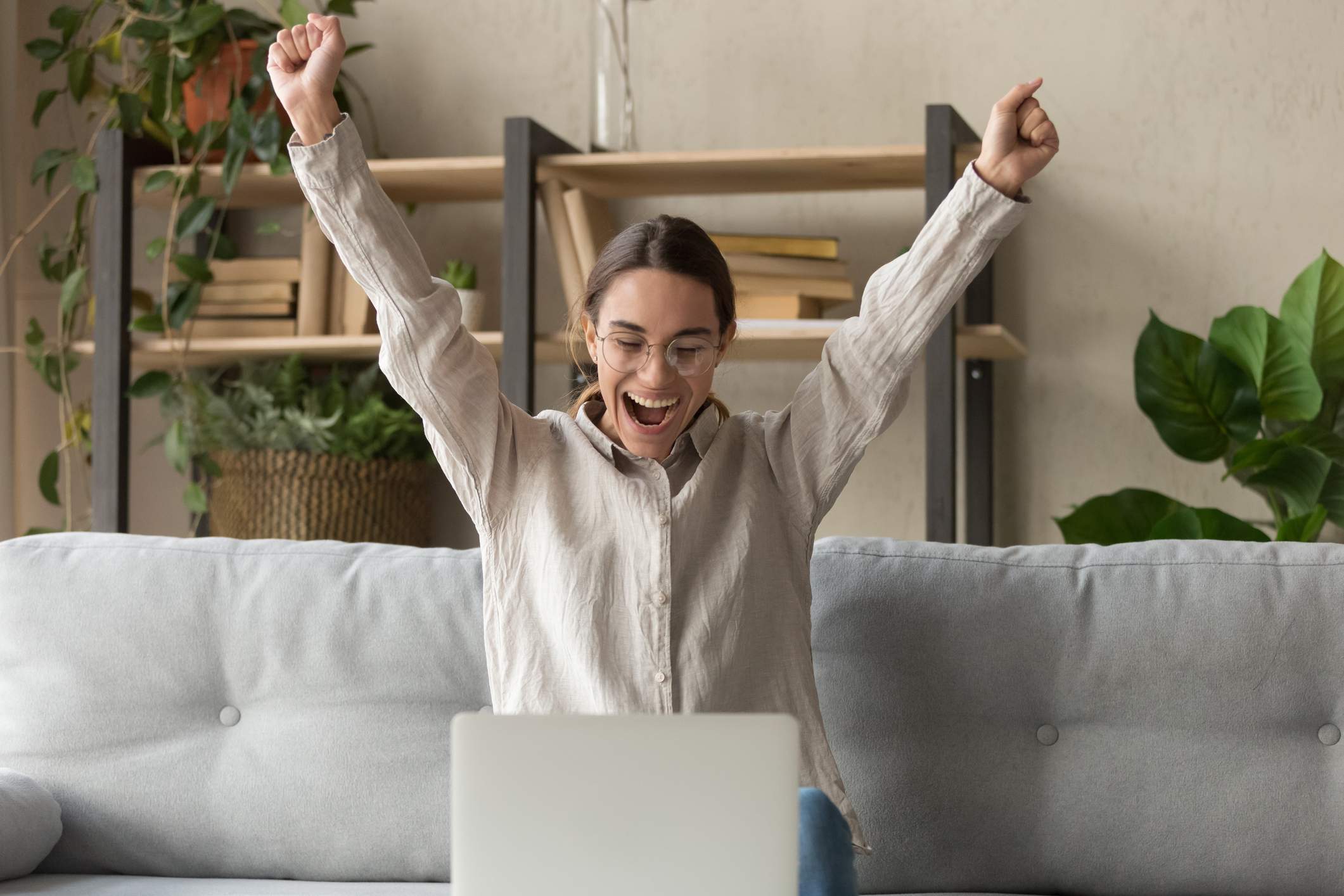 Woman-celebrating-and-raising-both-arms-above-her-head-power-poses