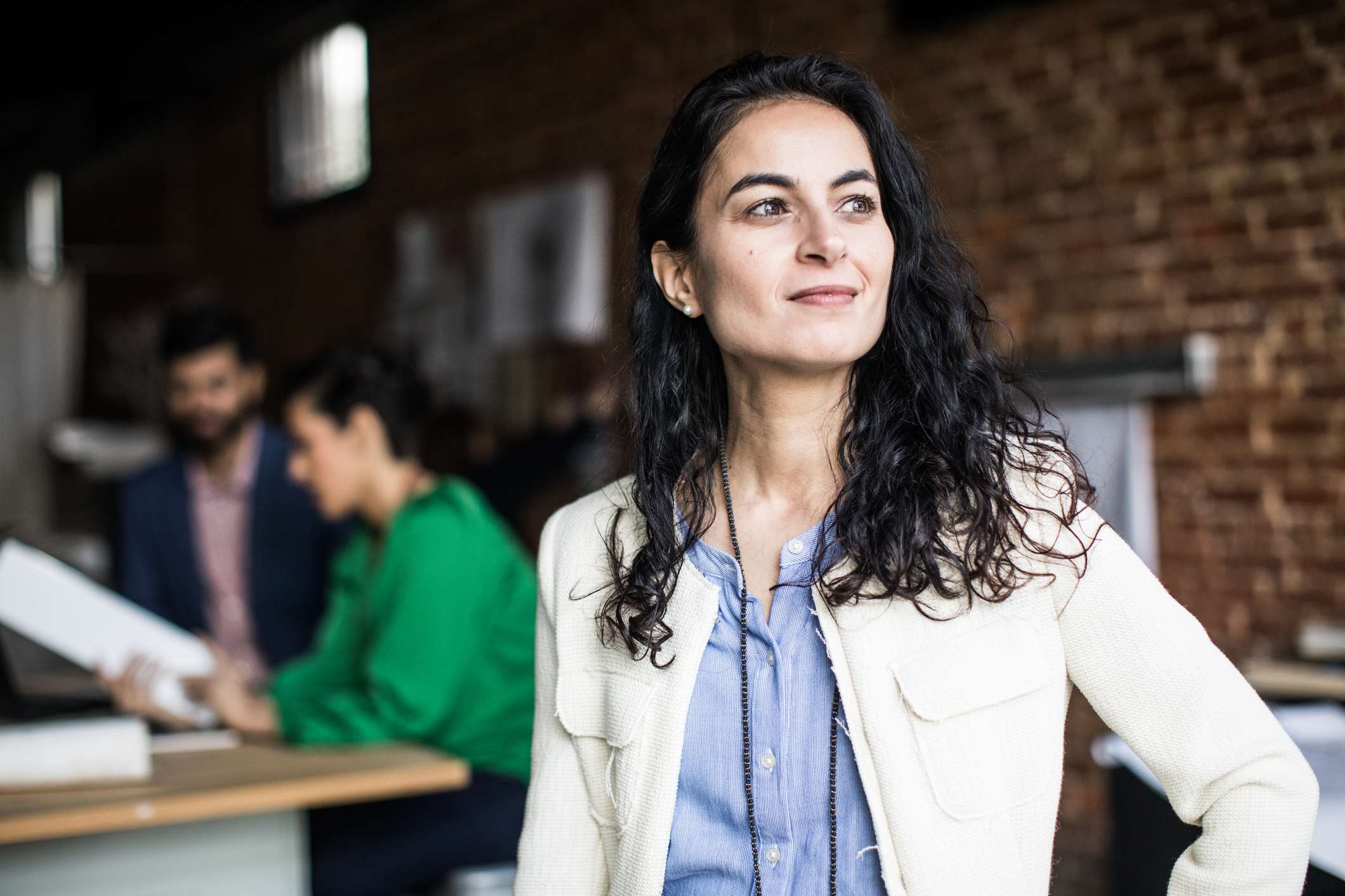 Woman-doing-power-pose-at-her-office-how-to-help-someone-with-imposter-syndrome