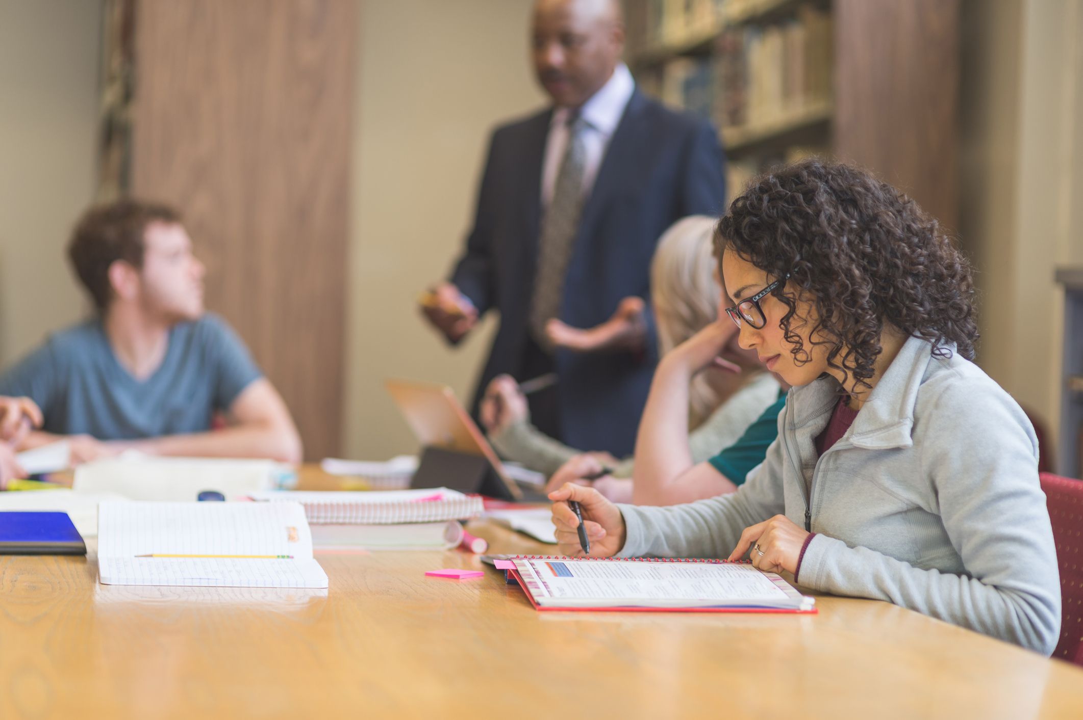 Woman-doing-research-in-laptop-at-library-is-a-masters-degree-worth-it