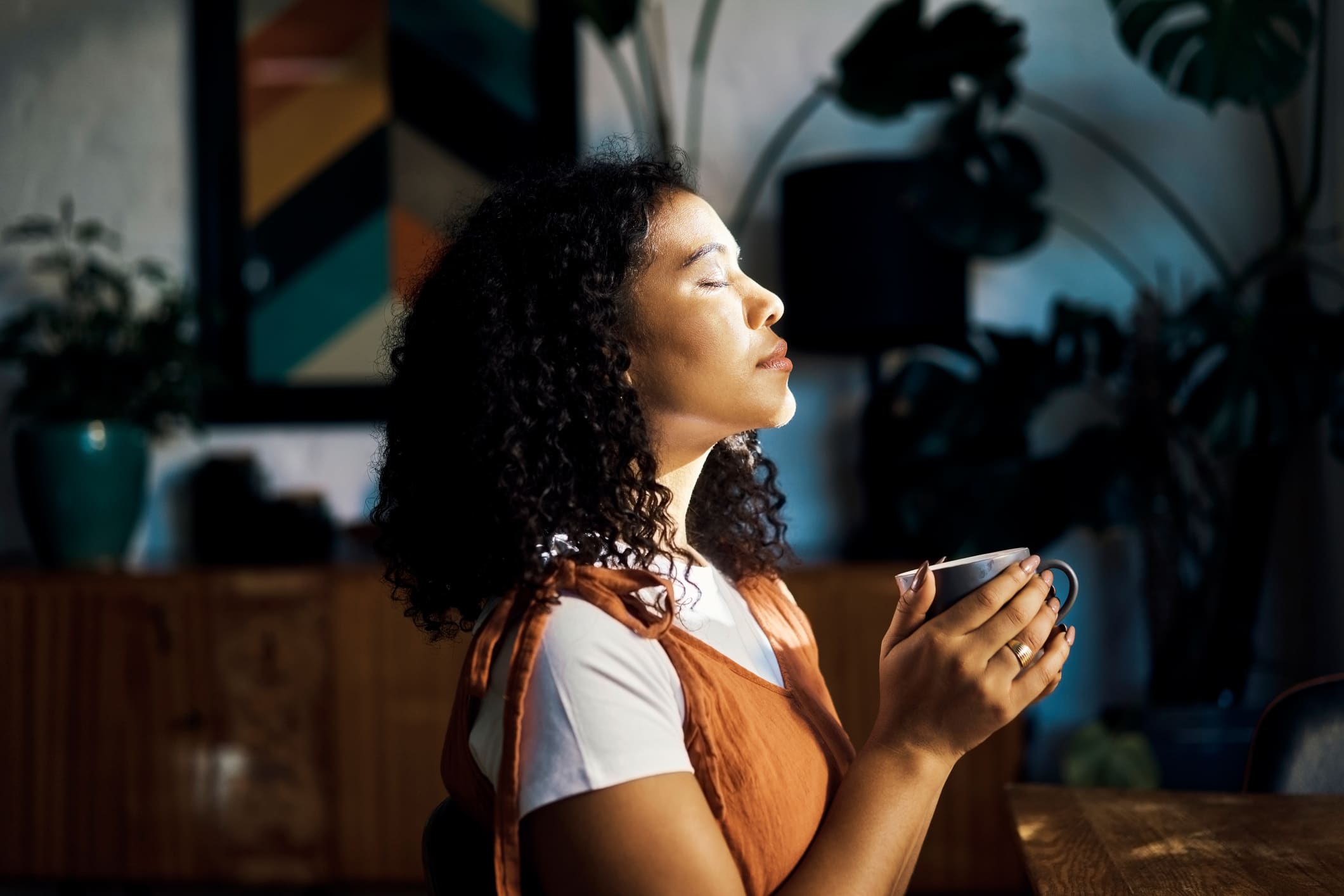 Woman-drinking-tea-while-meditating-self-reflection