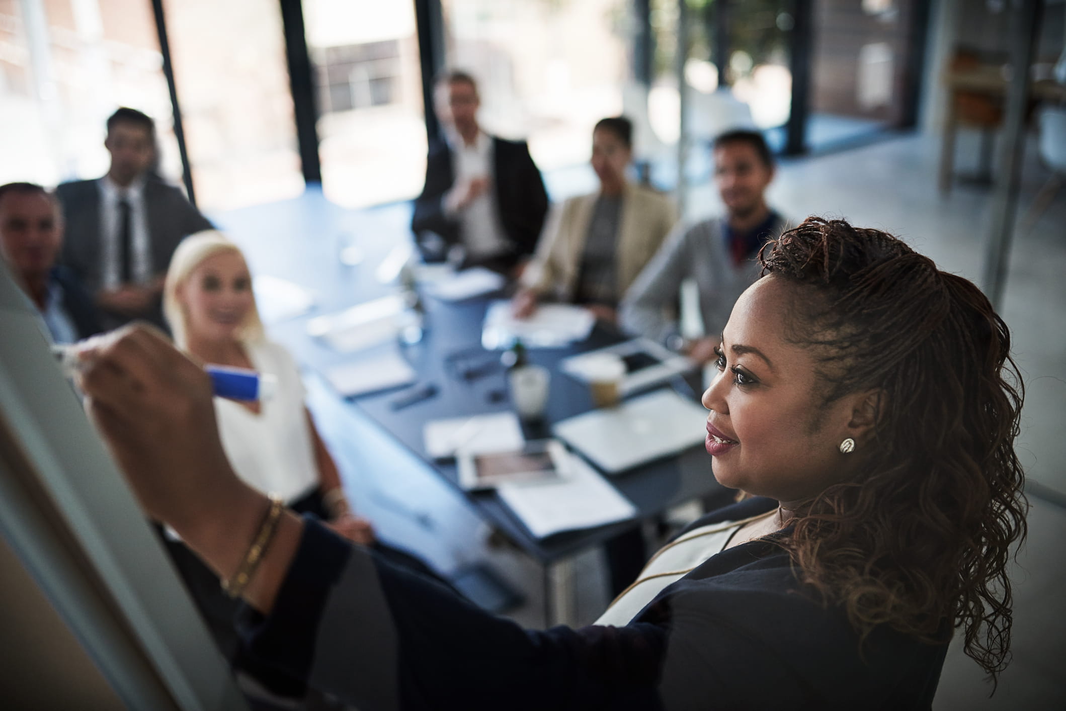 Woman-explaining-information-to-group-of-peers-internal-candidate