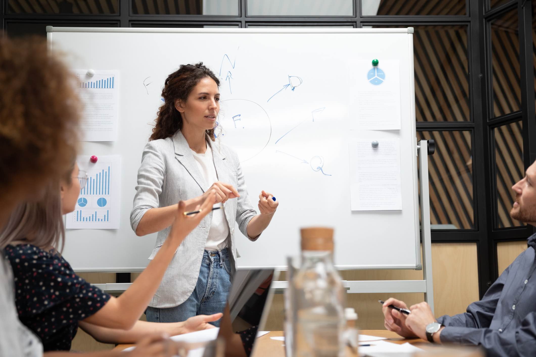 Woman-giving-management-presentation-to-coworkers-what-is-management-consulting