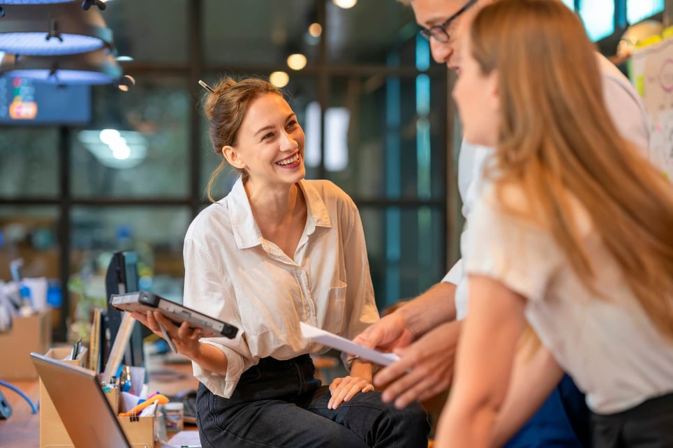 Woman-laughing-with-two-of-her-collegues-at-office-love-languages-at-work