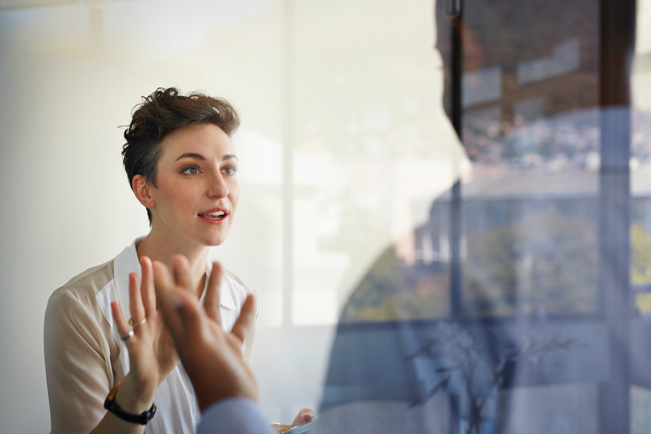 Woman-looking-angry-while-talking-to-coworker-breaking-down-silos