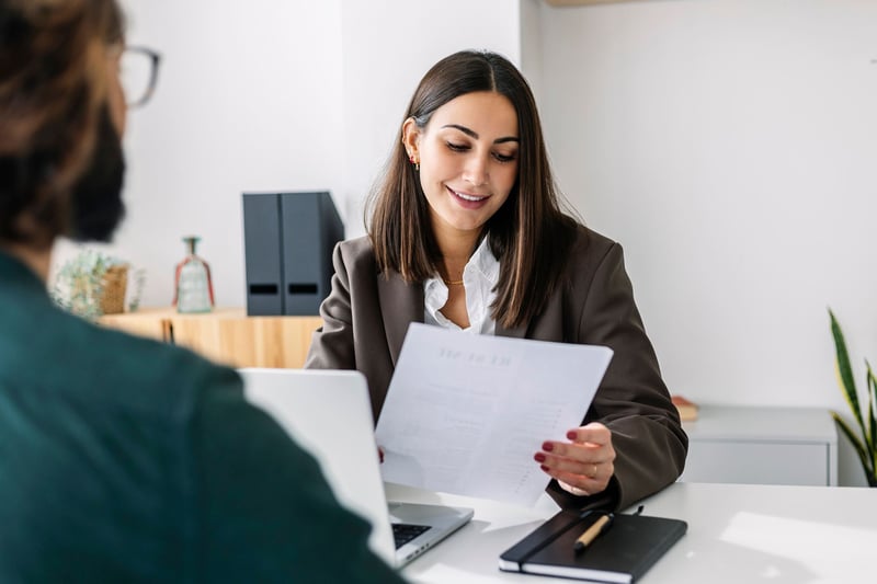 Woman-looking-at-her-resume-at-interview-hiring-manager-vs-recruiter