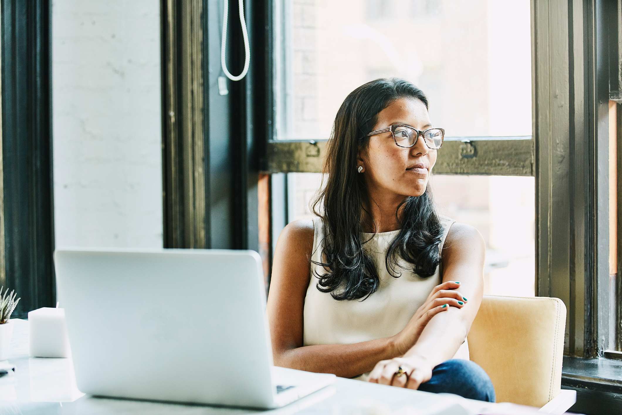 Woman-looking-happily-through-a-window-what-motivates-you