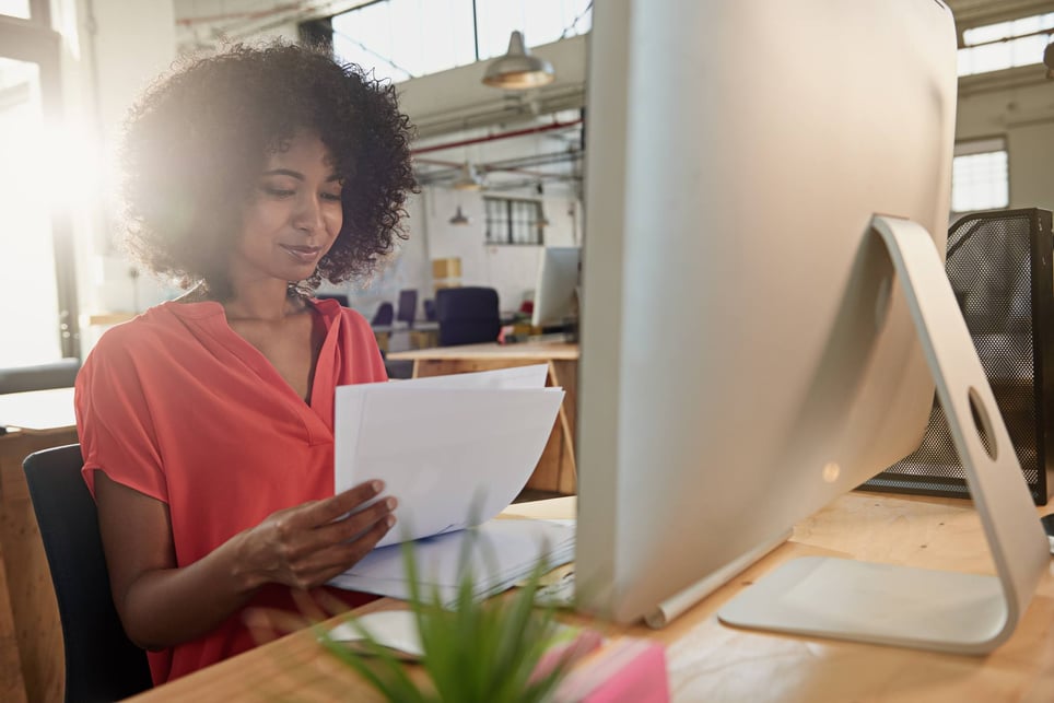 Woman-manager-working-happily-at-office-how-to-stop-micromanaging