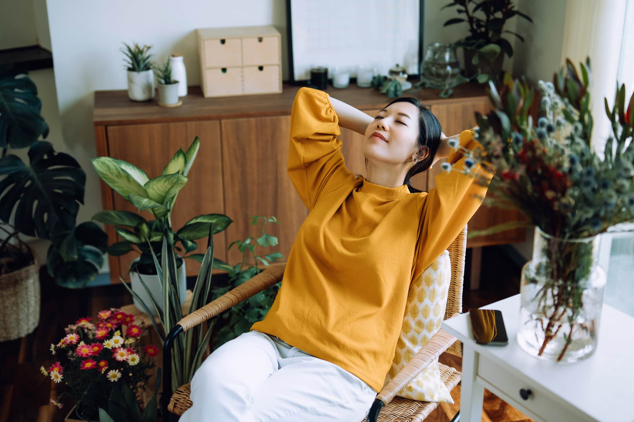 Woman-relaxing-at-her-plant-filled-office-what-is-emotional-distress