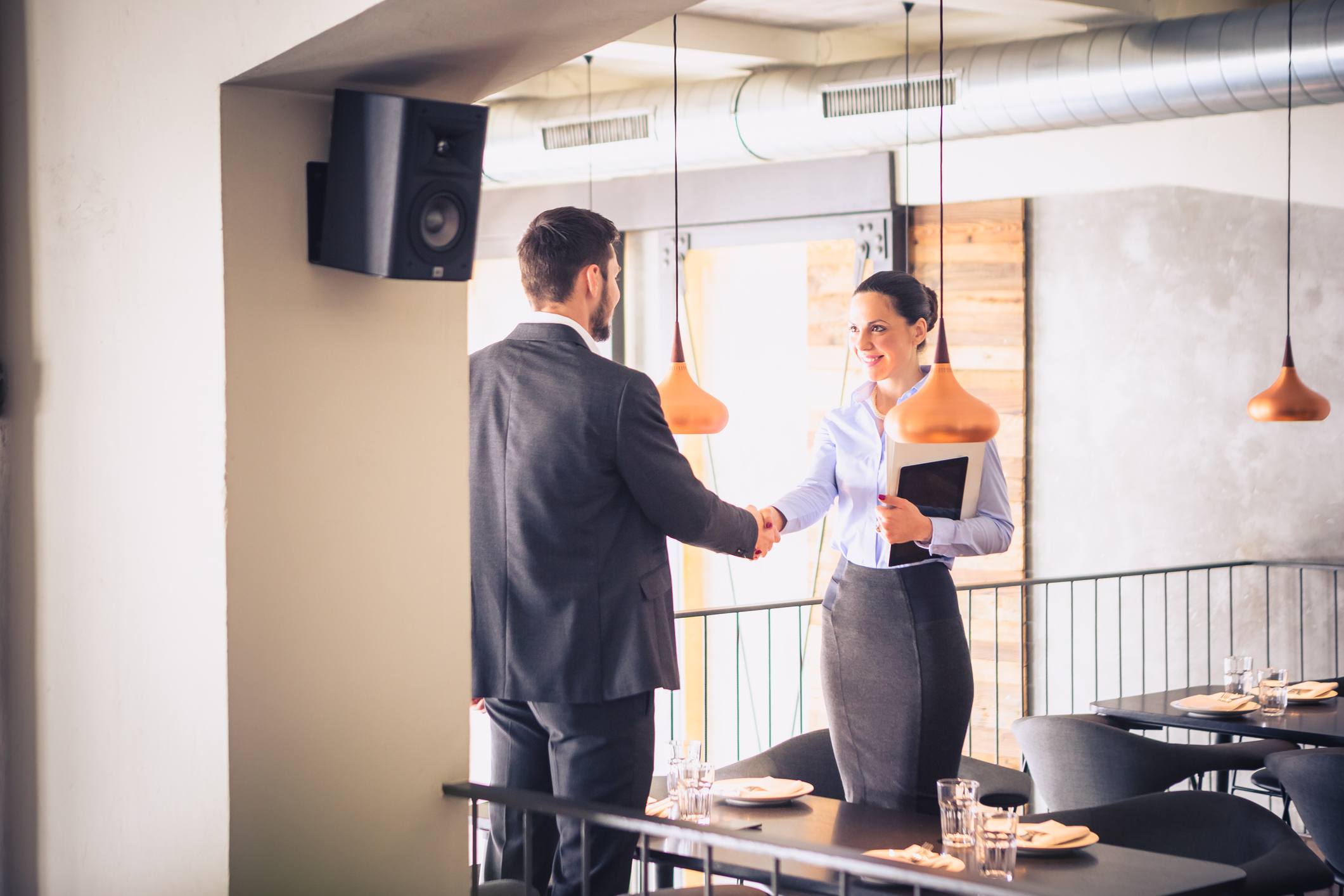 Woman-shaking-hand-of-interviewer-at-office-problem-solving-questions