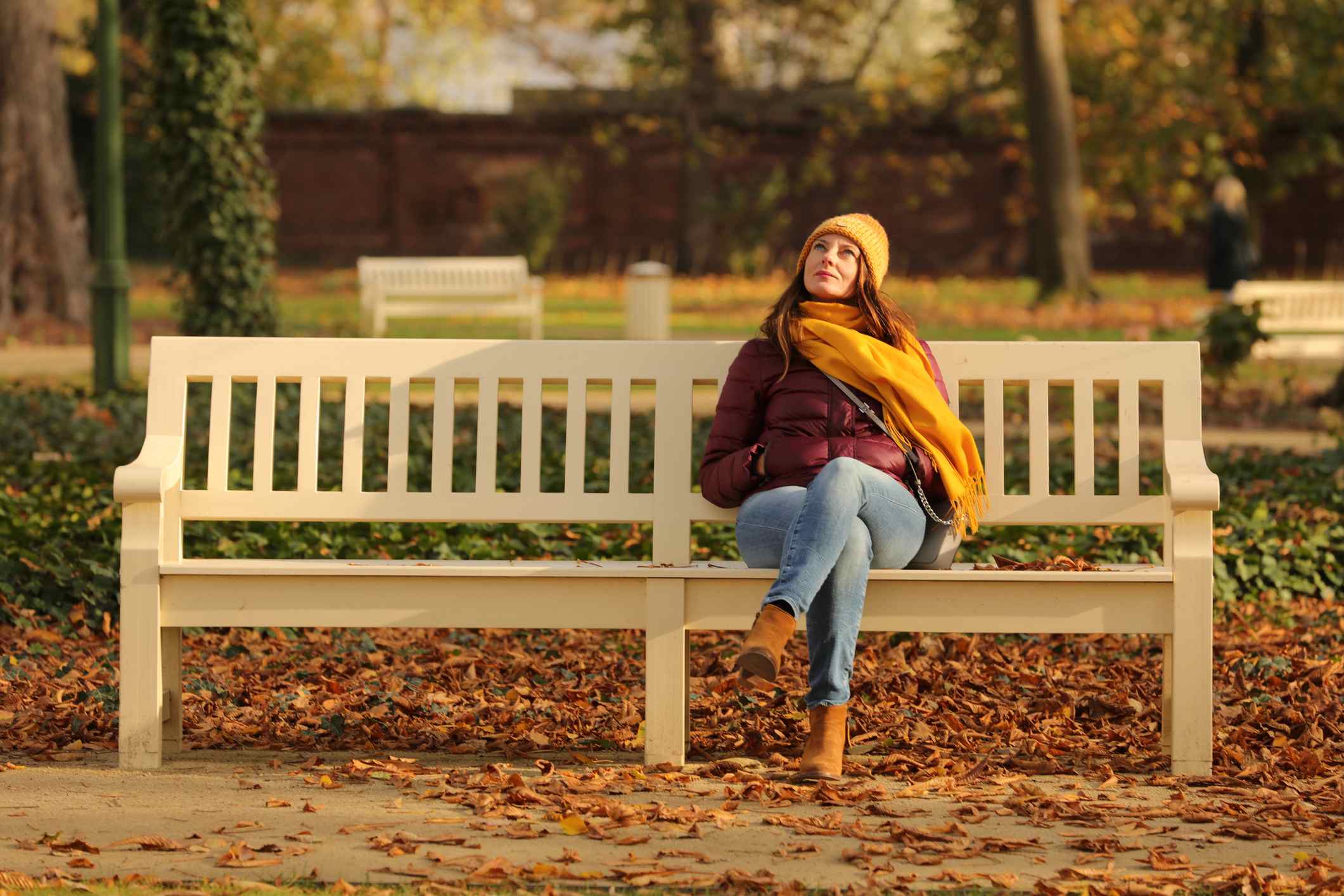 Woman-sitting-at-bench-in-park-the-importance-of-taking-breaks