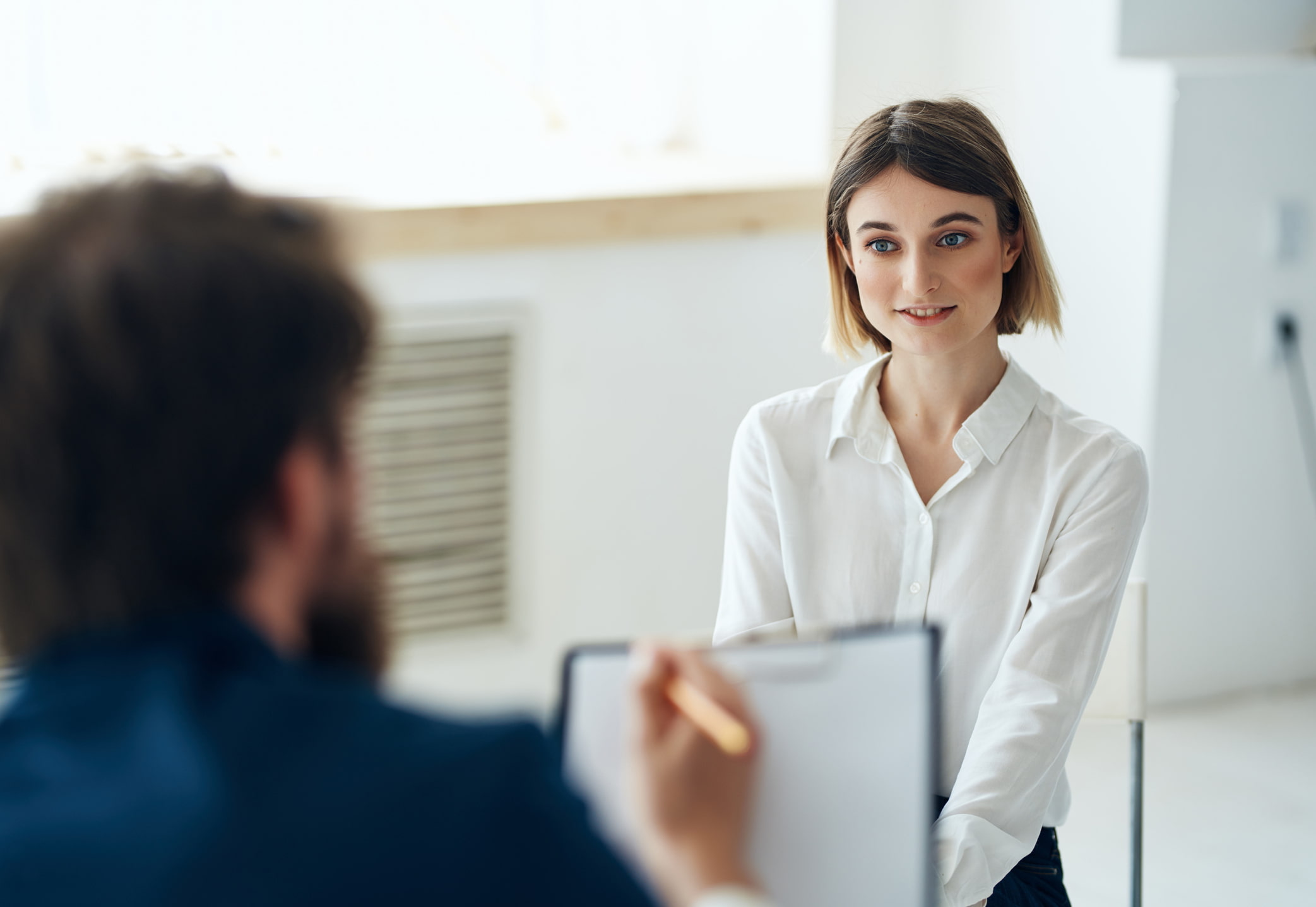 Woman-sitting-at-serious-job-interview-structured-interview