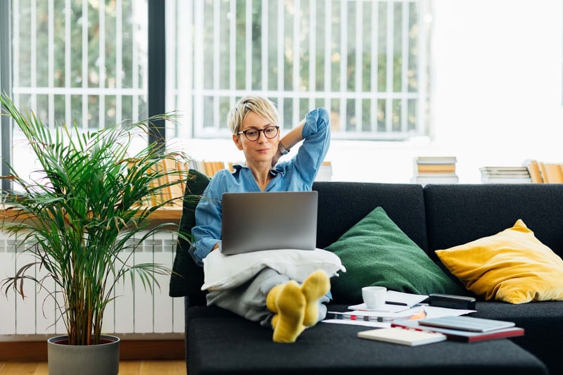 Woman-sitting-on-couch-working-at-home