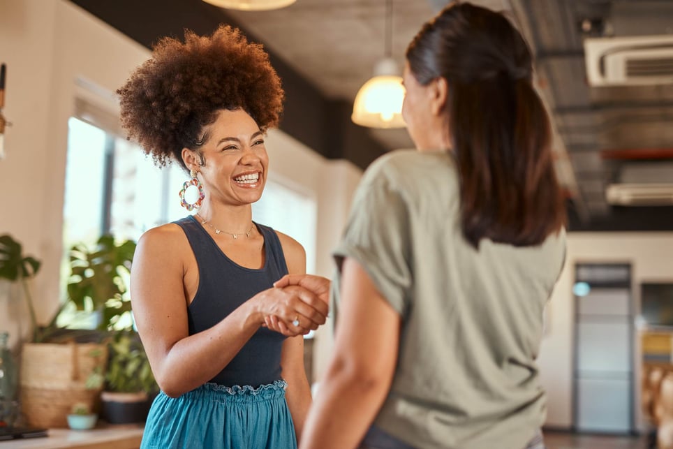 Woman-smiling-and-congratulating-coworker-how-to-congratulate-someone-on-a-promotion