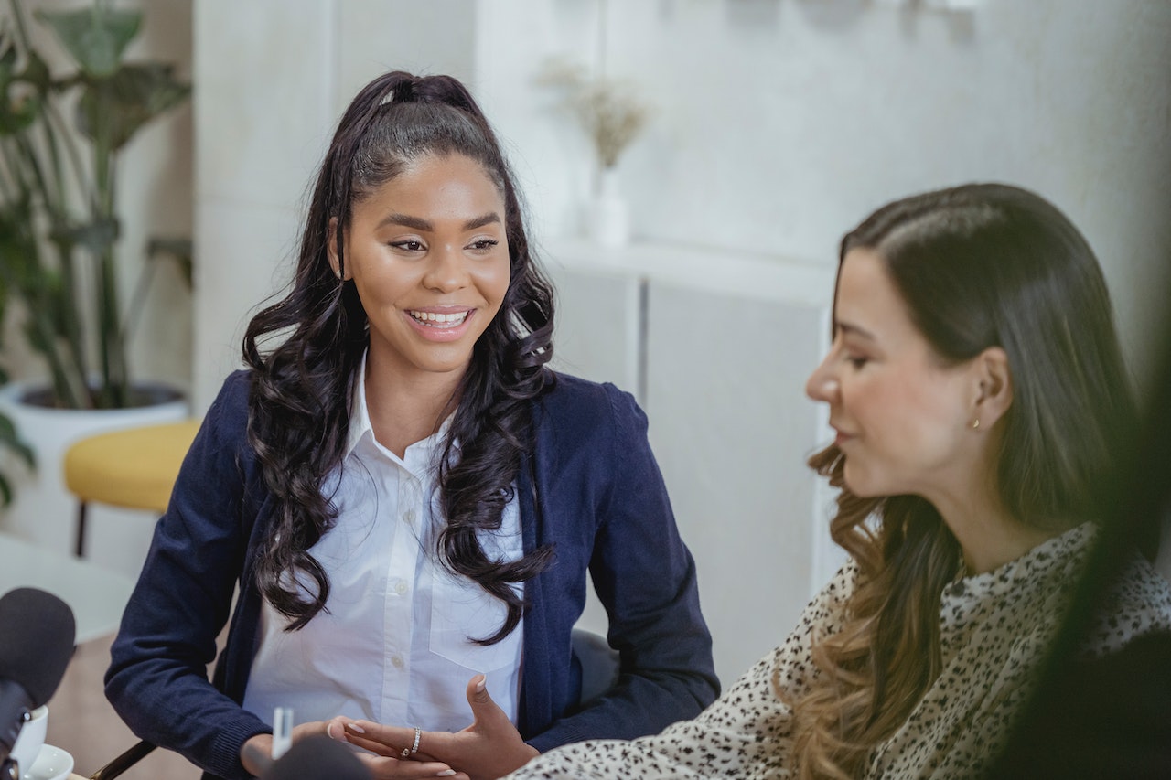 Woman-smiling-while-looking-at-coworker-talking-7-38-55-rule