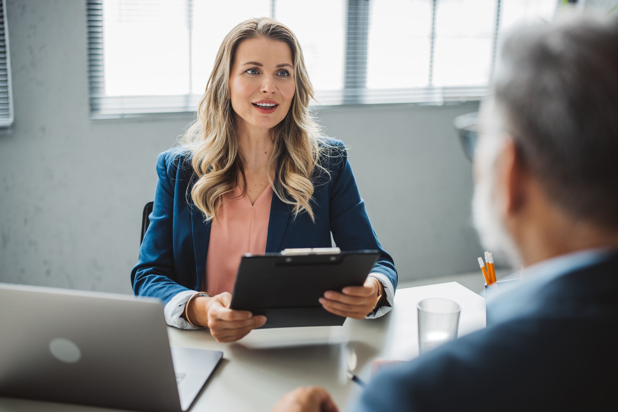 Woman-talking-to-coworker-at-office-employee-owned-companies