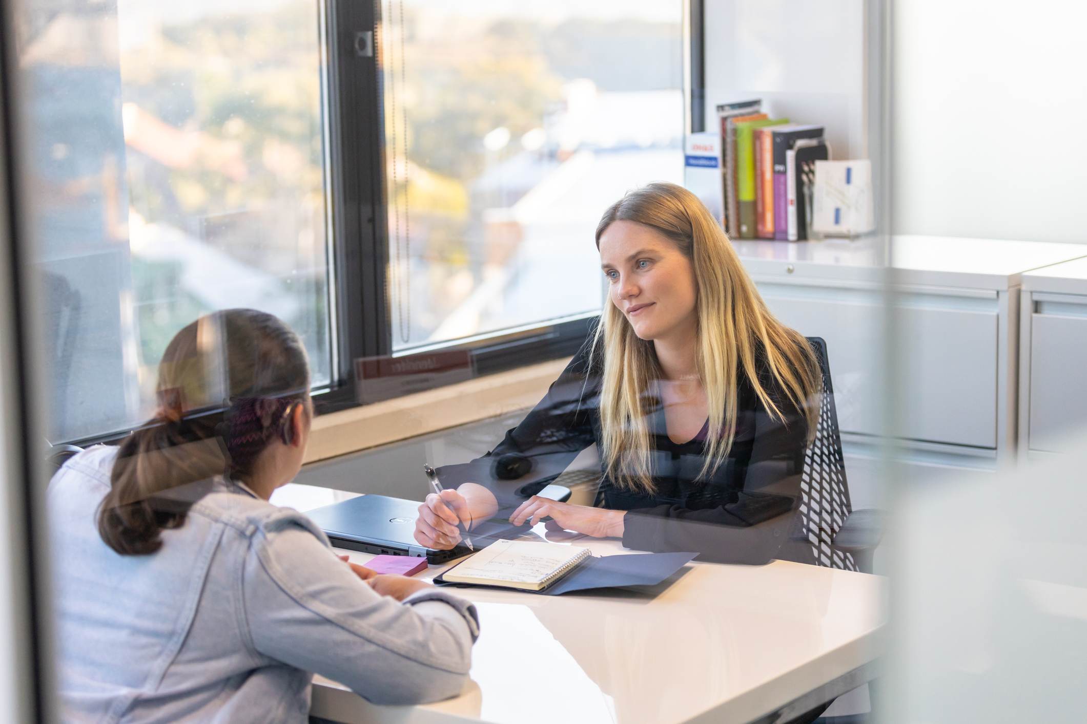 Woman-talking-to-her-manager-at-office-promotion-interview-questions