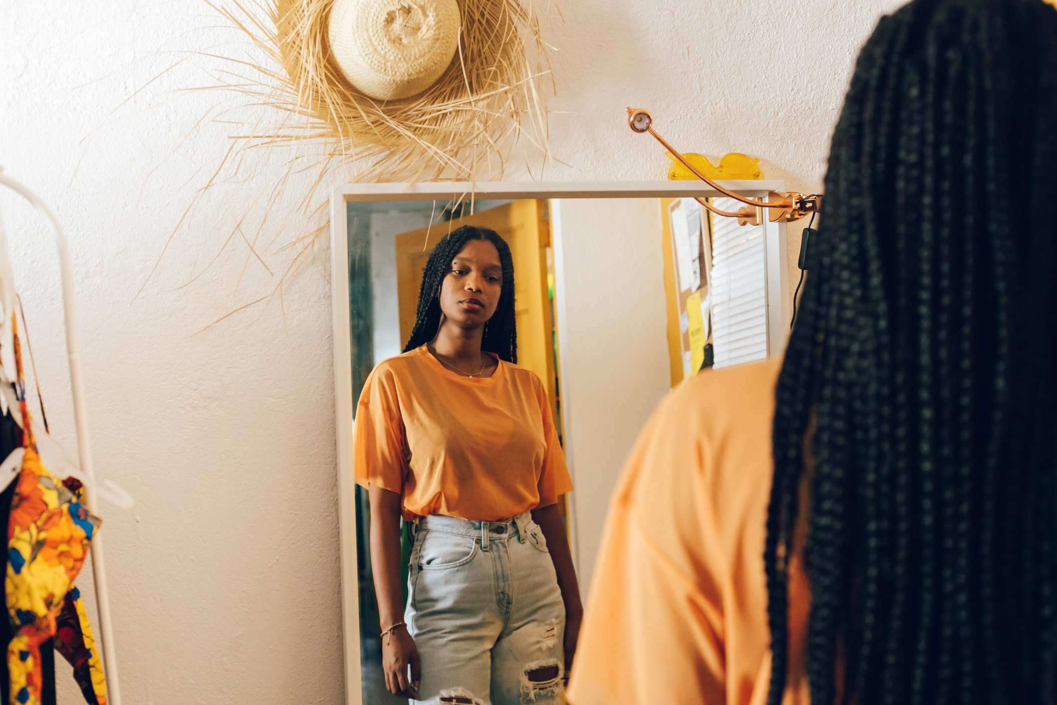 Woman-uncomfortable-looking-at-herself-in-the-mirror-spotlight-effect