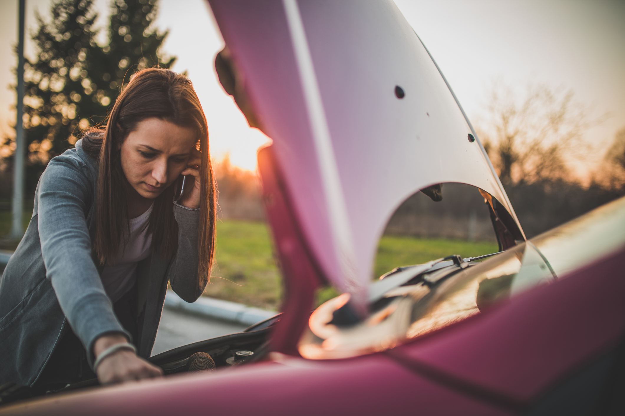 Woman-with-car-problems-on-the-street-talking-on-phone-absenteeism