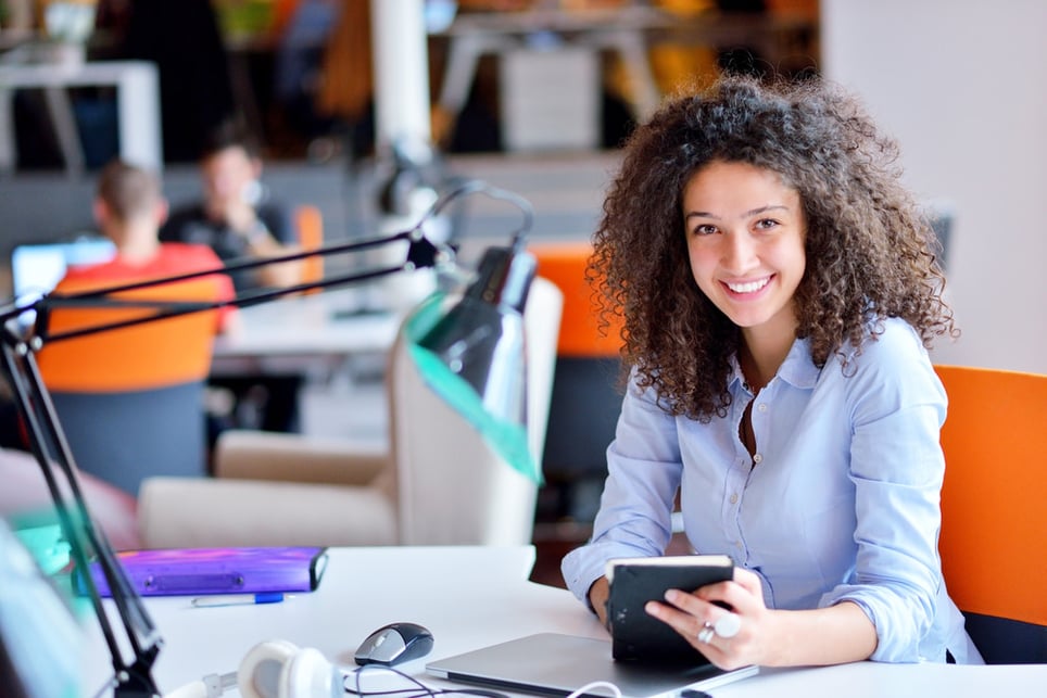 Woman-working-in-an-office-and-smiling-work-life-balance-for-managers