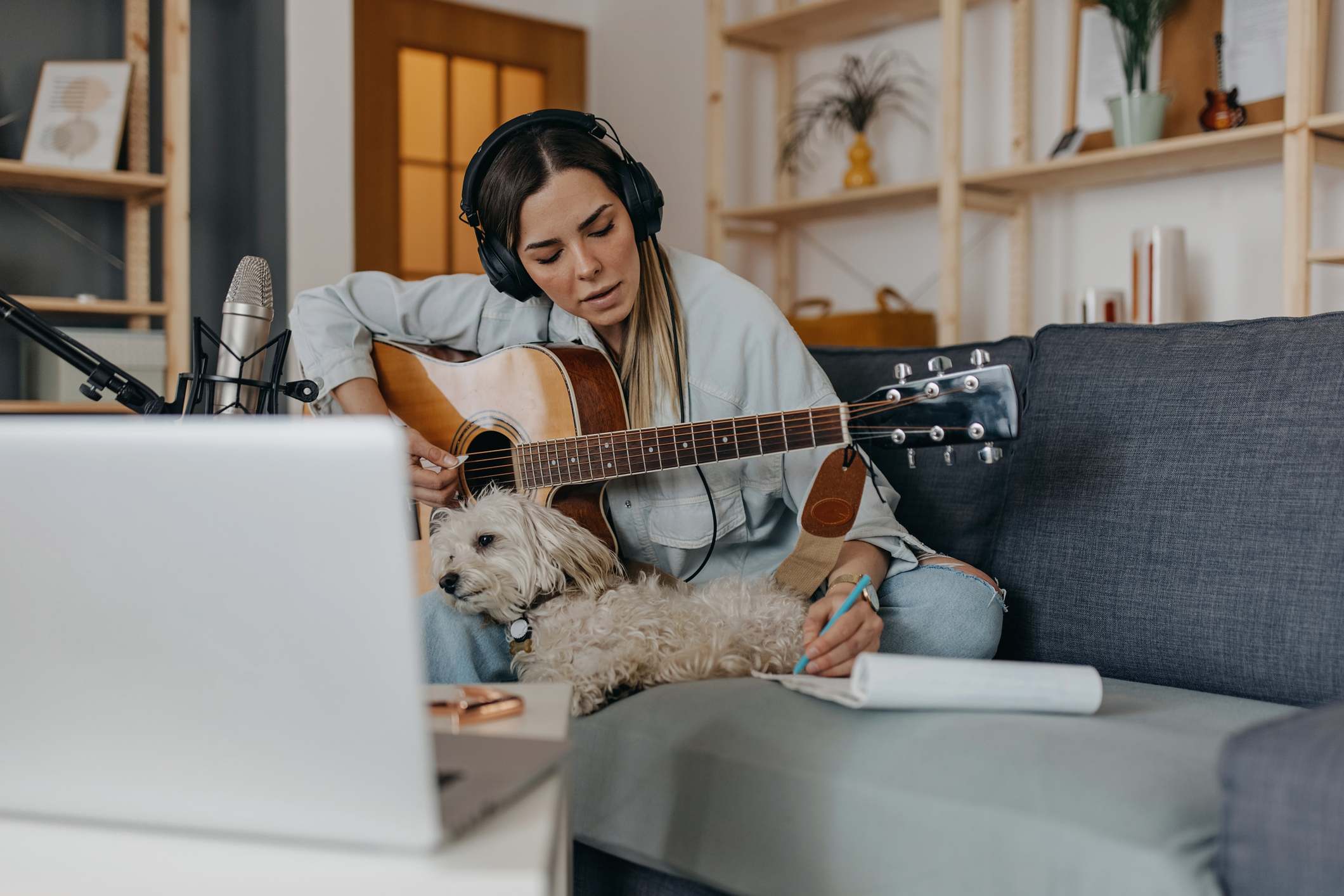 Woman-writing-song-with-dog-music-relaxation-for-stress