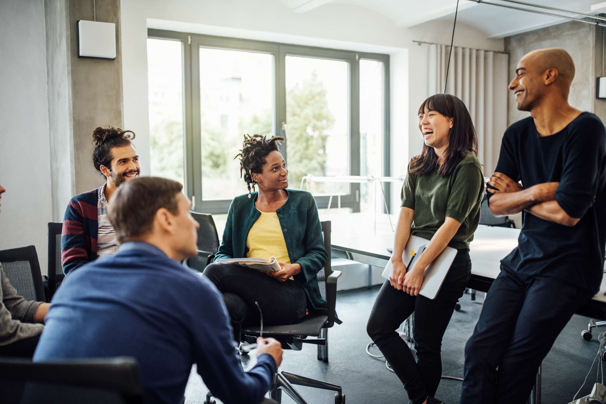 Work-team-at-office-smiling-and-talking-teamwork-skills