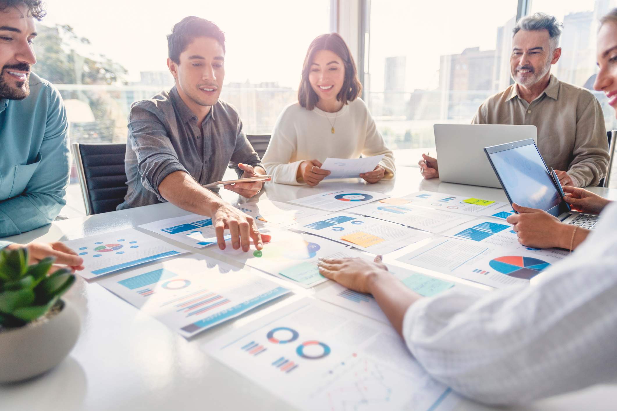 Work-team-looking-at-charts-on-table-best-jobs-with-business-degree