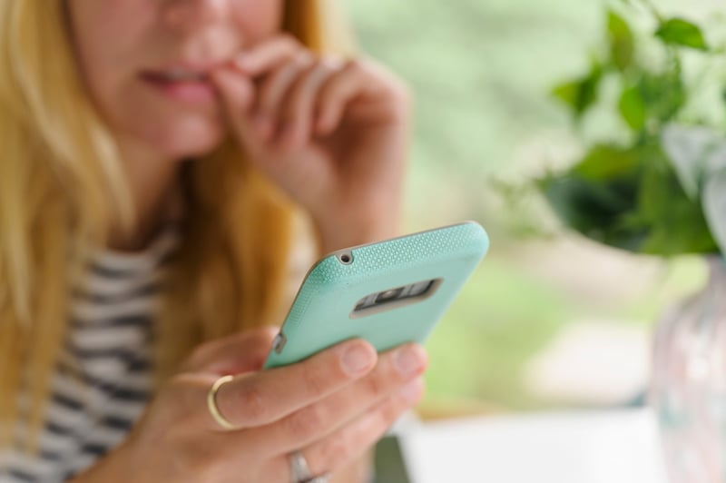 Worried-Woman-Looking-At-Phone-phone-anxiety