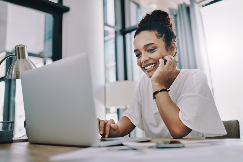 Young-black-woman-looking-at-laptop-happy-letter-of-intent