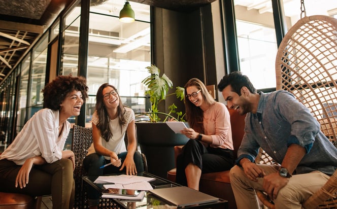 Young-business-team-talking-and-laughing-in-break-room-work-life-balance-for-managers-1