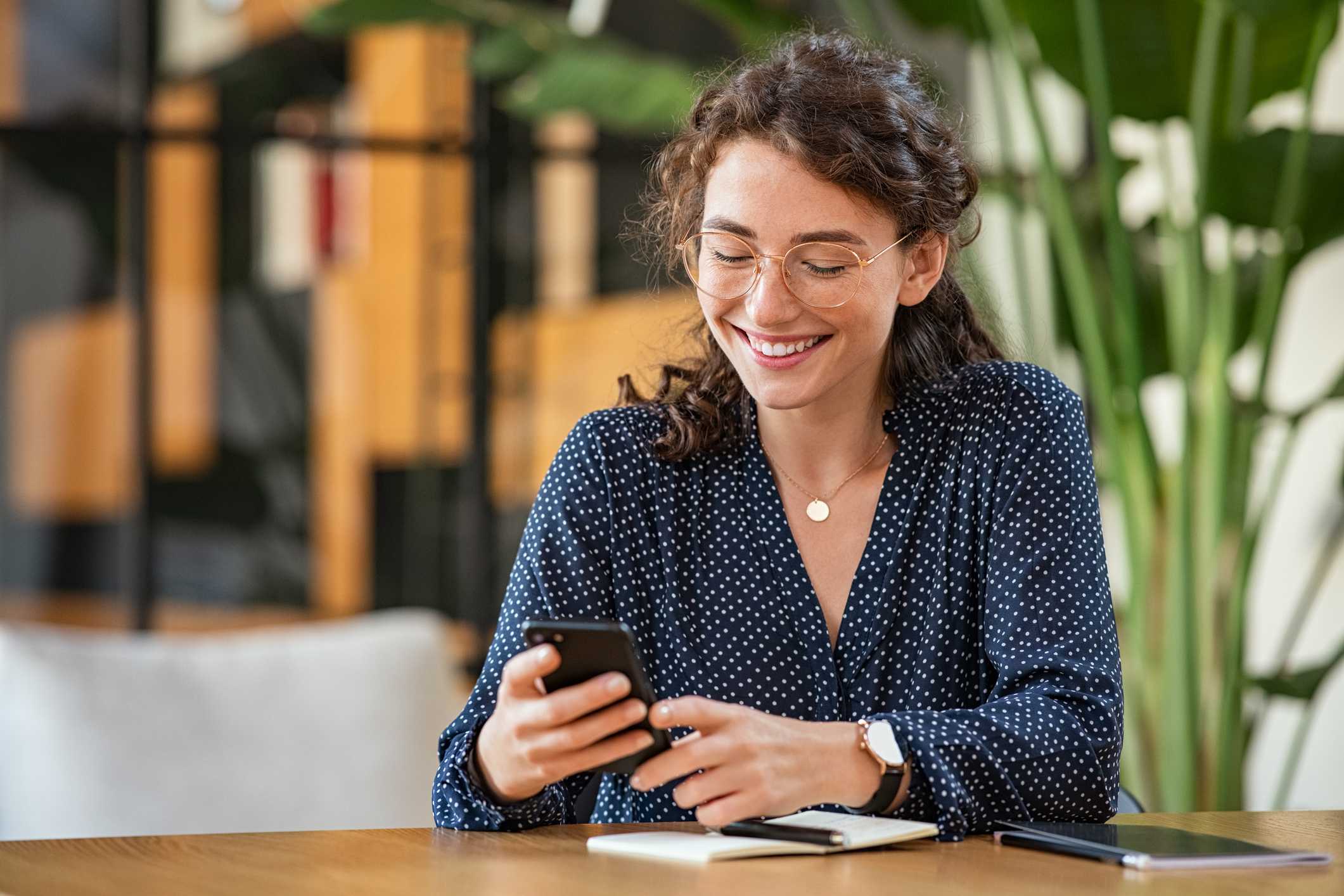 Young-businesswoman-using-smartphone-phone-screen-interview