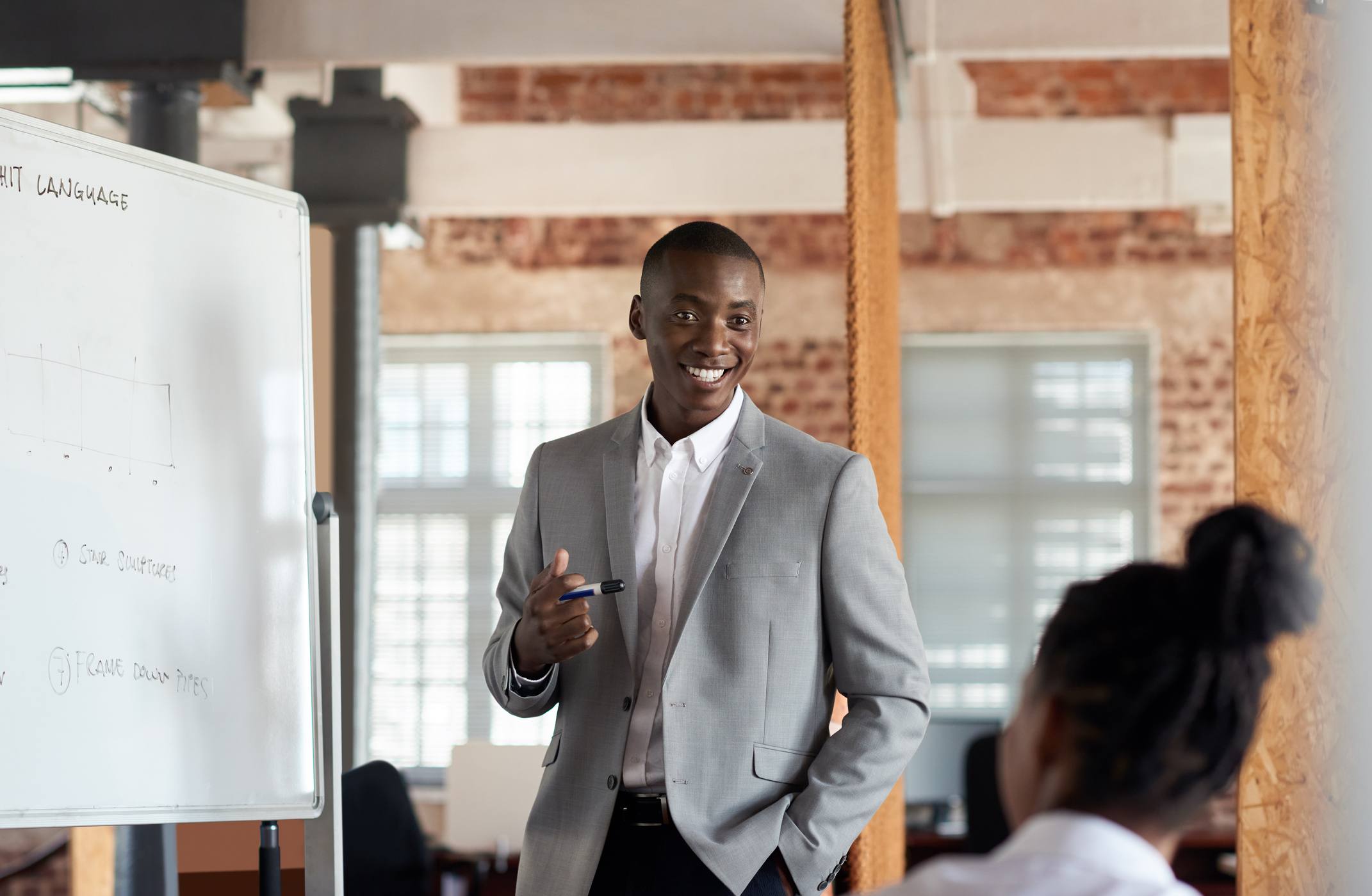 Young-man-giving-a-presentation-at-work-how-to-write-a-linkedin-summary