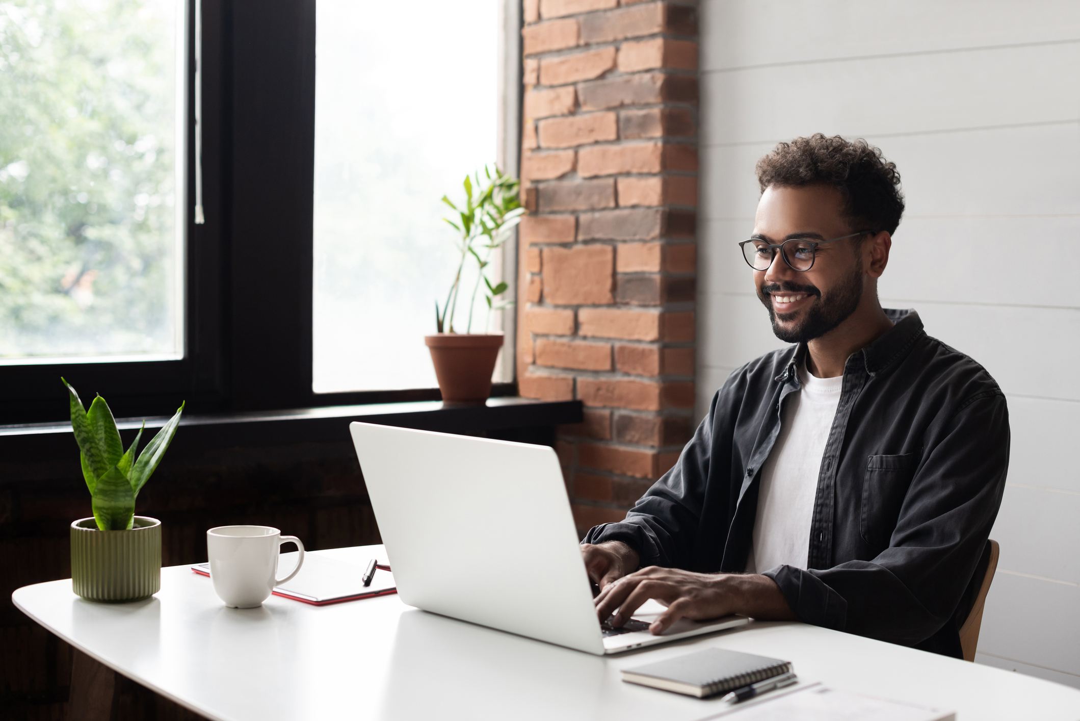 Young-man-working-from-home-how-to-decide-between-current-job-and-new-job