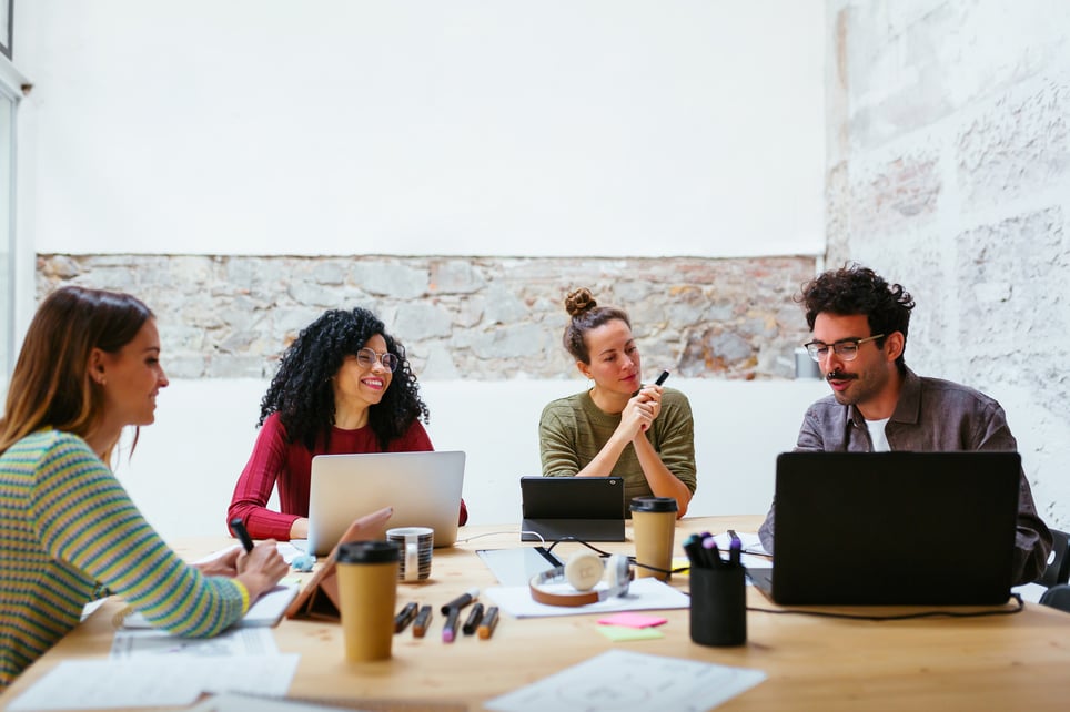 Young-team-working-together-in-a-meeting-room-what-is-teamwork