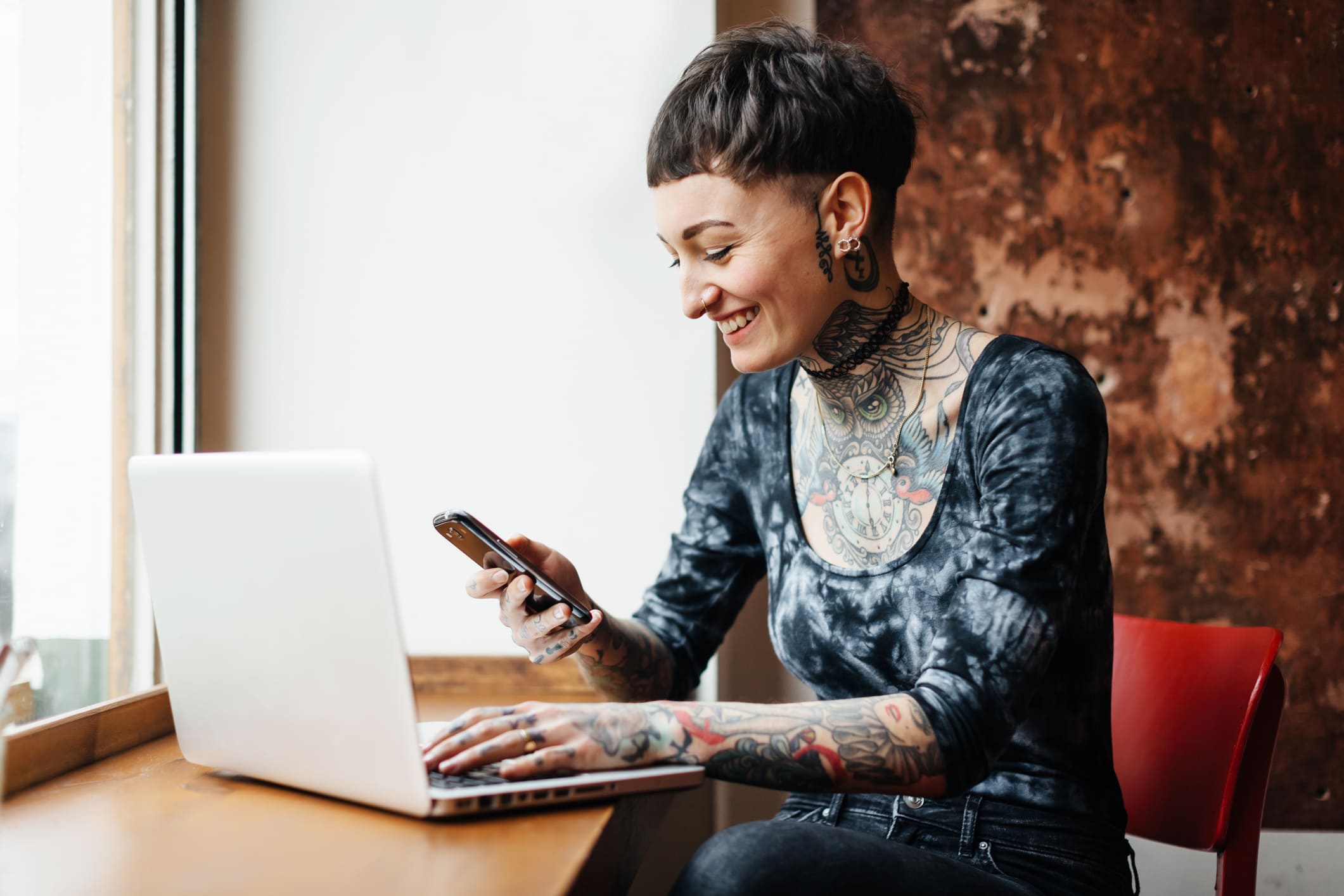 Young-woman-checking-phone-after-redacting-email-how-to-reject-internship-offer