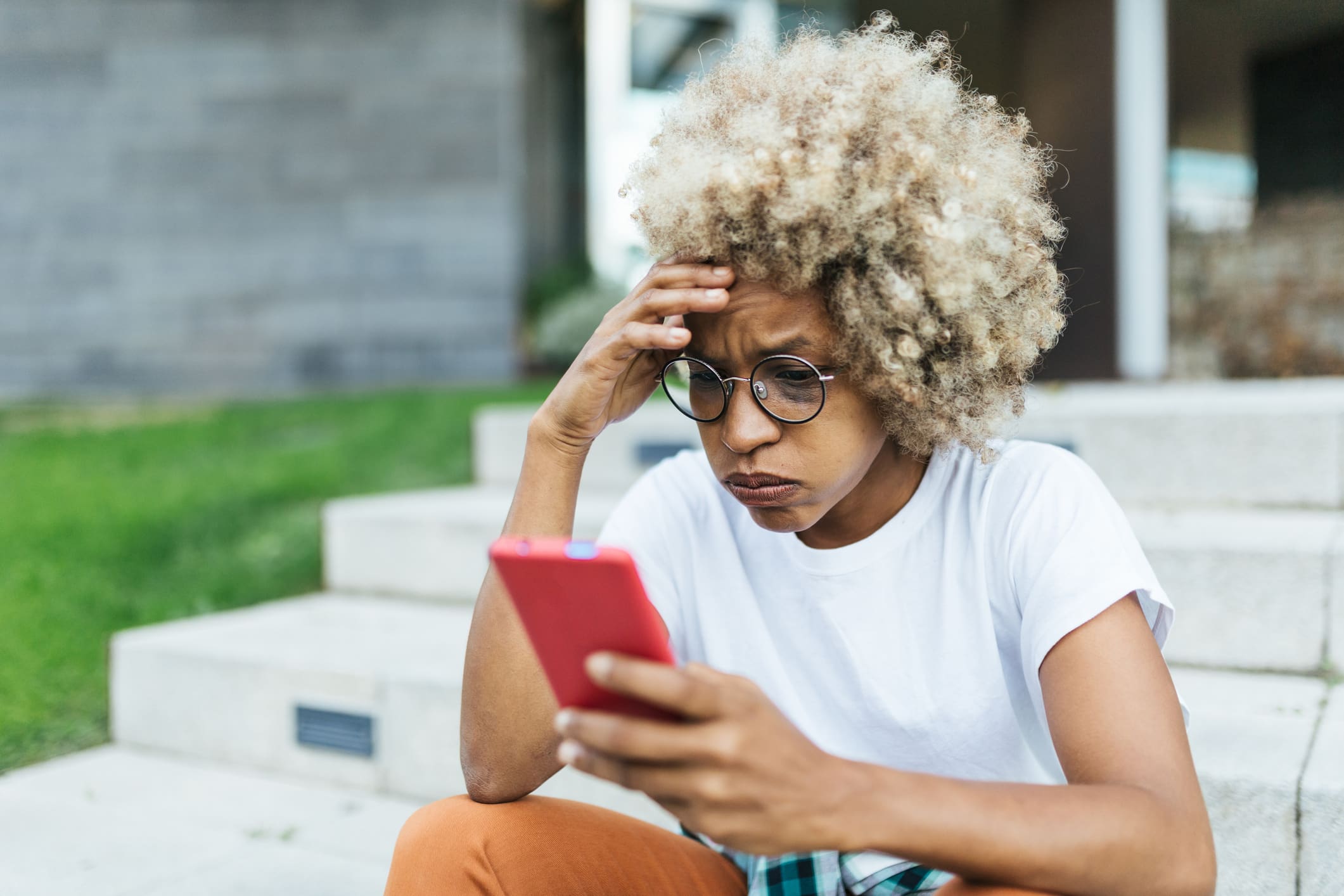 Young-woman-stressed-looking-at-her-phone-how-to-protect-yourself-from-toxic-empathy