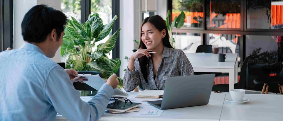 asian-woman-in-modern-office-smiling-working-as-a-contractor-vs-employee