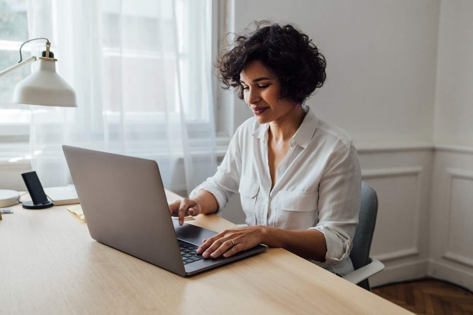 beautiful-female-working-with-laptop-interview-follow-up-email-after-2-weeks