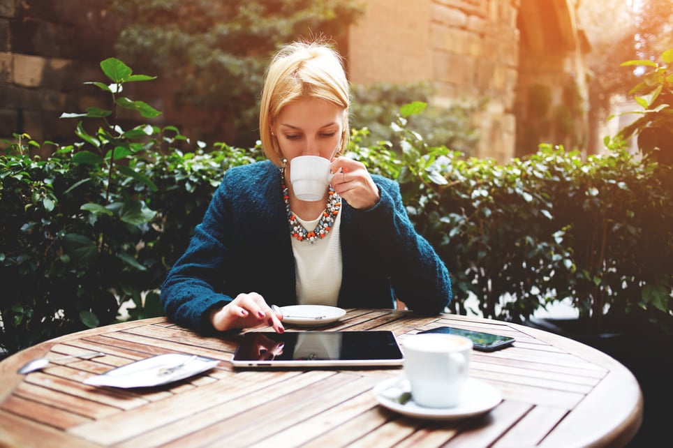 blond-well-dressed-woman-using-ipad-while-sitting-in-coffee-shop-work-life-balance-for-managers