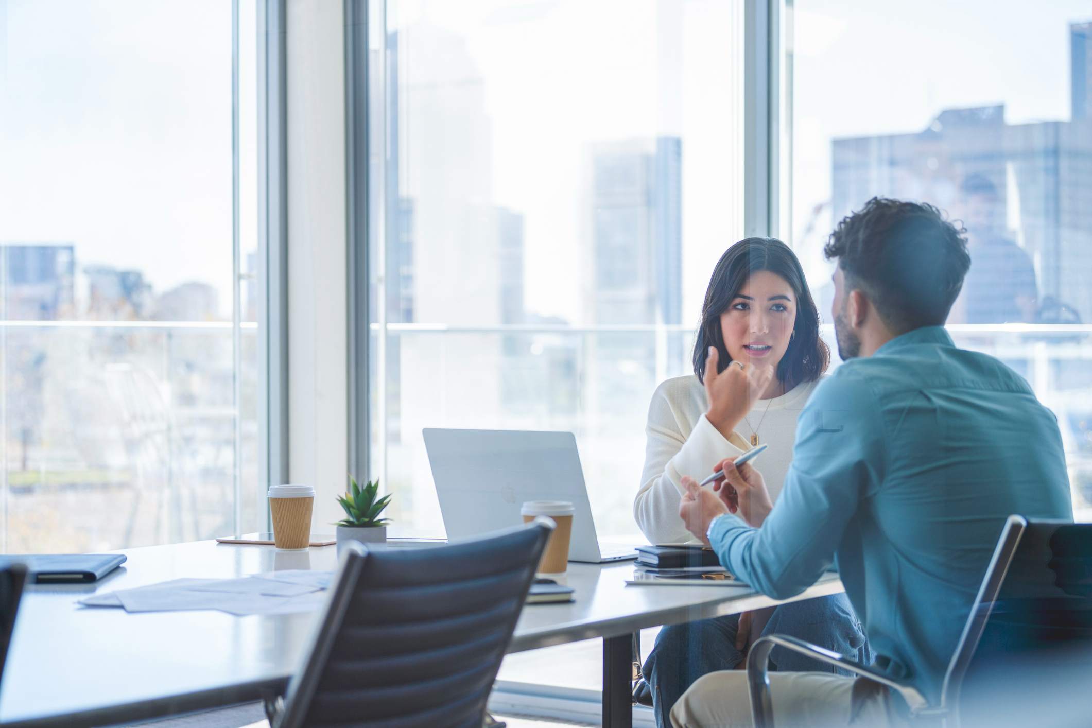 business-woman-and-man-at-meeting-interview-follow-up-email-after-2-weeks