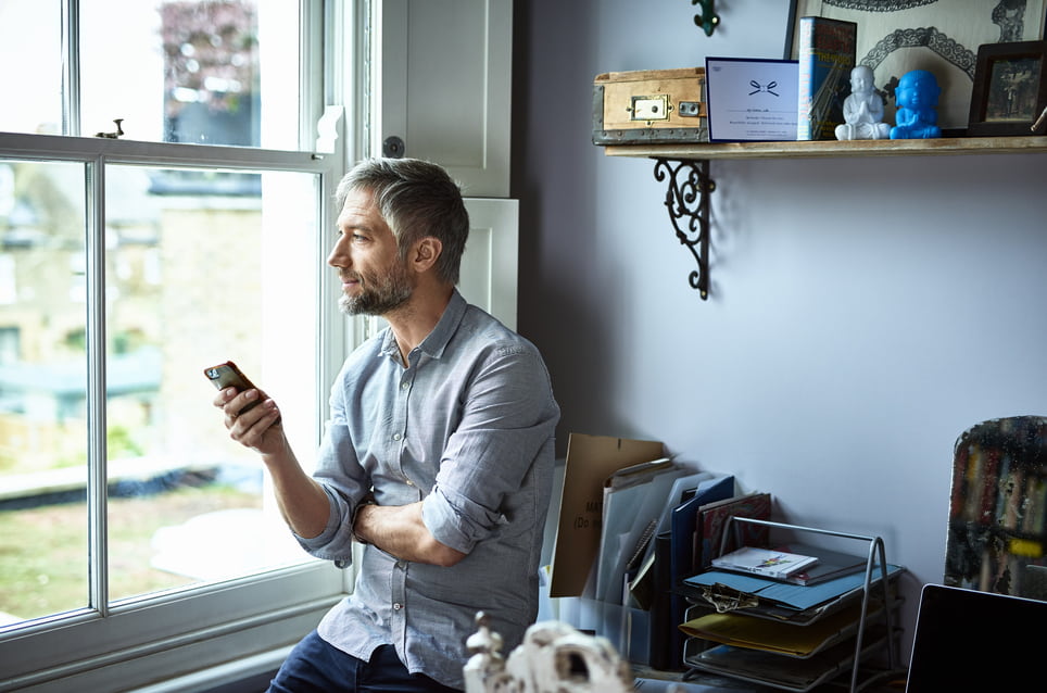 businessman-looking-through-the-window-is-it-better-to-stay-at-one-company-or-move-around