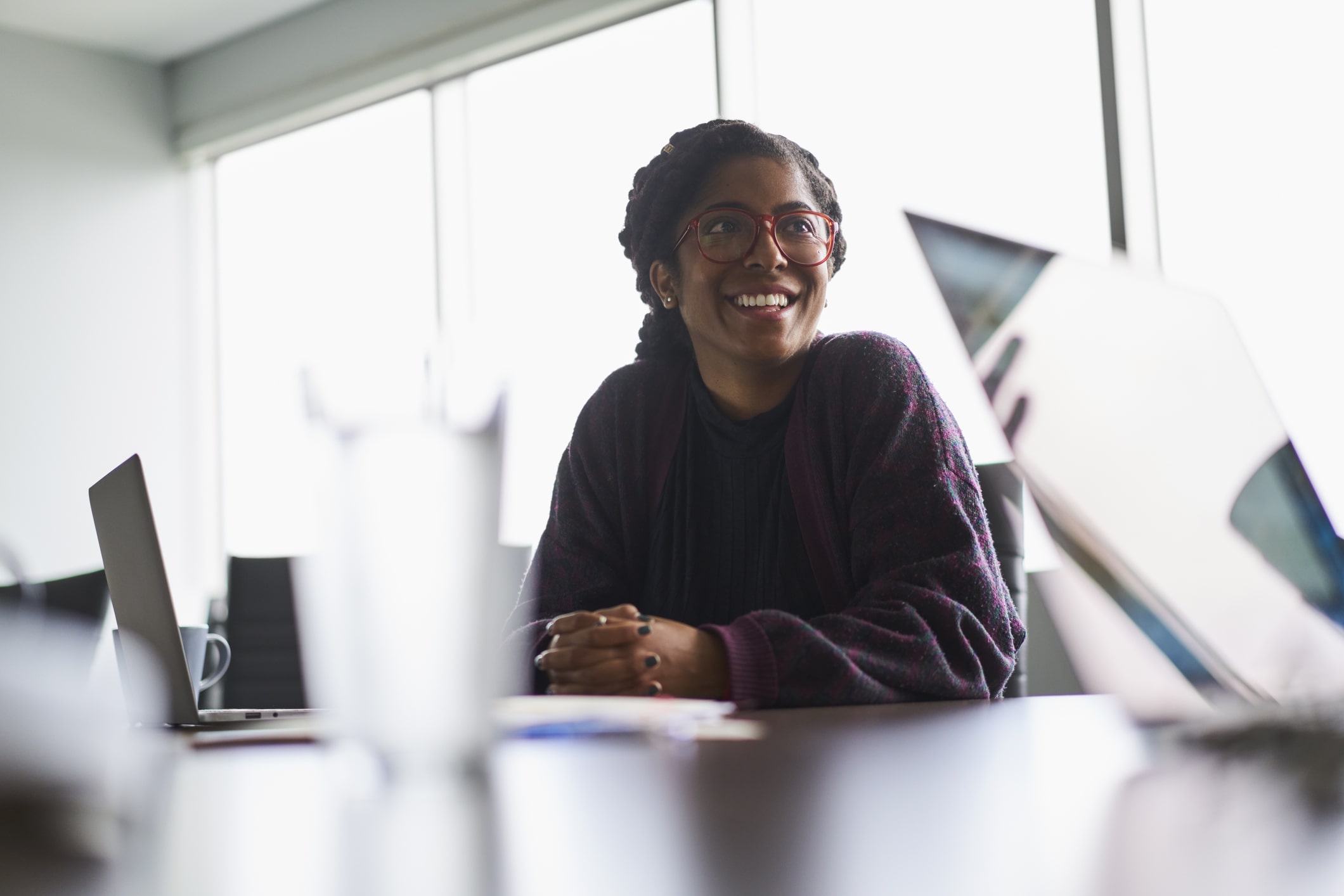 cheerful-woman-sitting-at-conference-table-at-business-meeting-effects-of-lack-of-focus