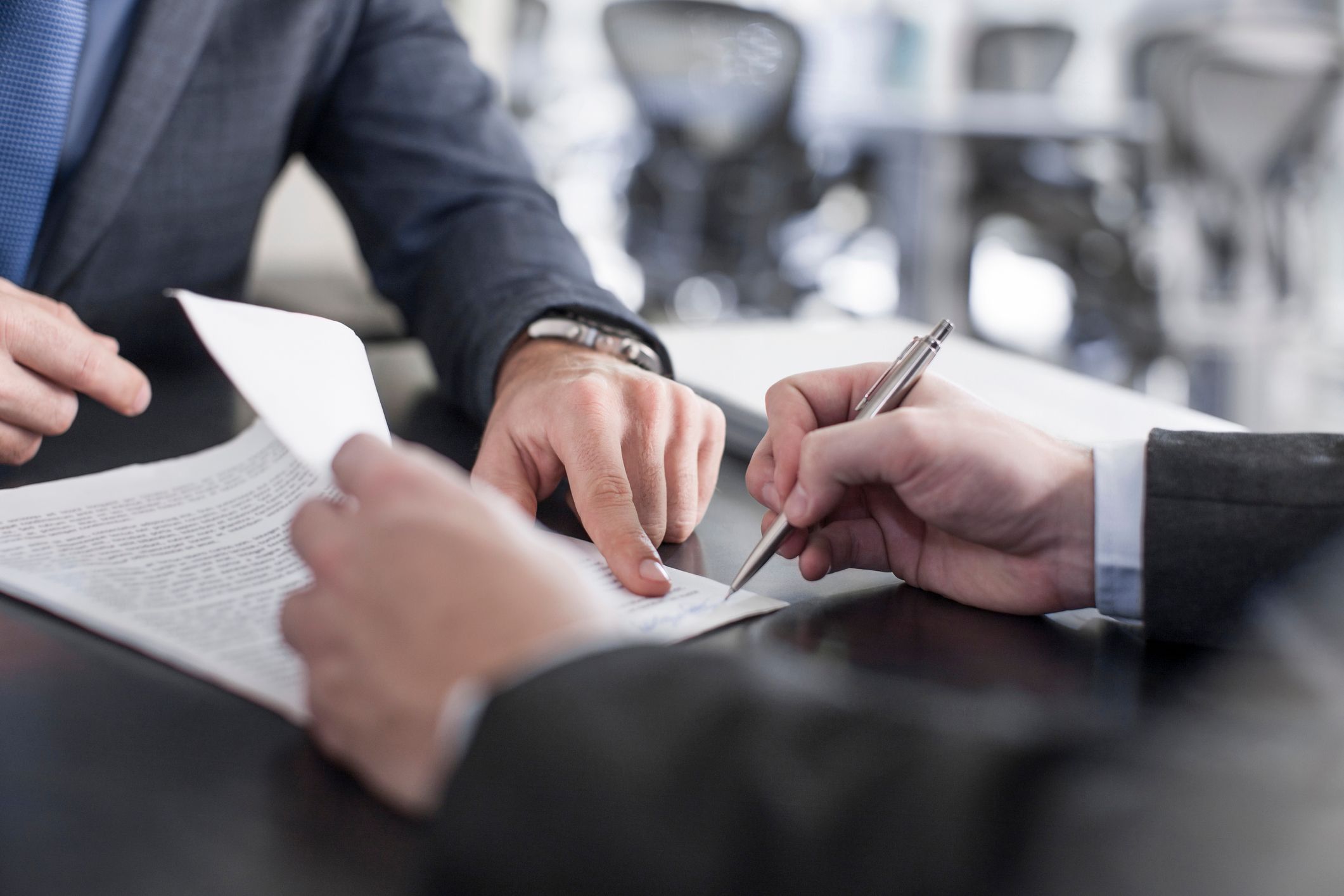 close-up-of-hands-signing-document-i-got-laid-off-without-warning