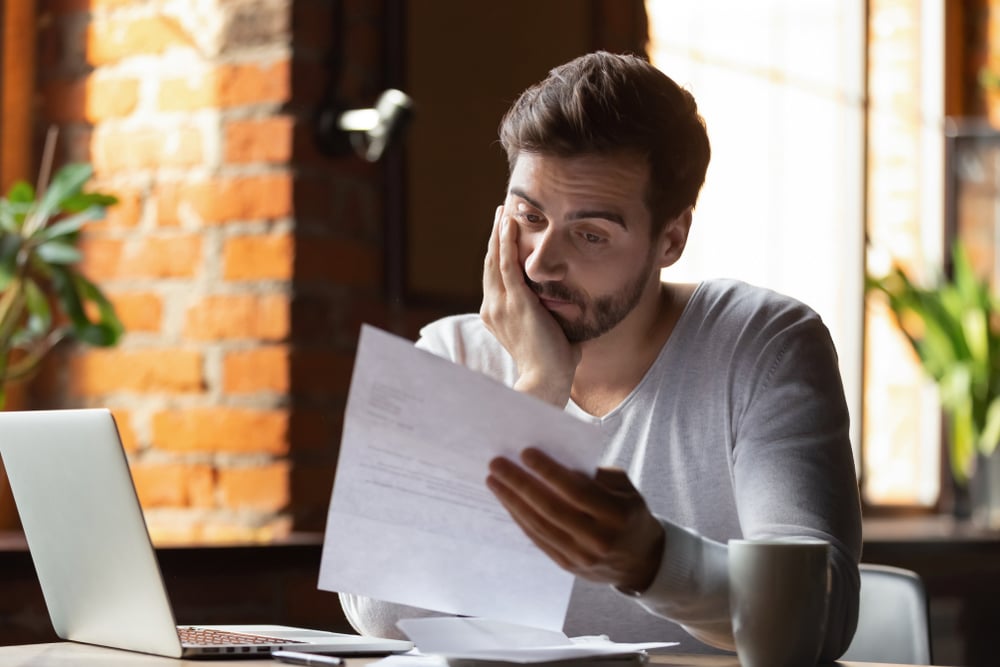 confused-frustrated-young-man-reading-letter-lack-of-concentration-and-anxiety